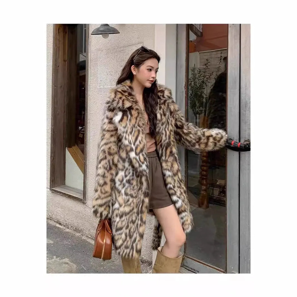 Long grey faux fur coat with a large fur collar and pockets on a model.