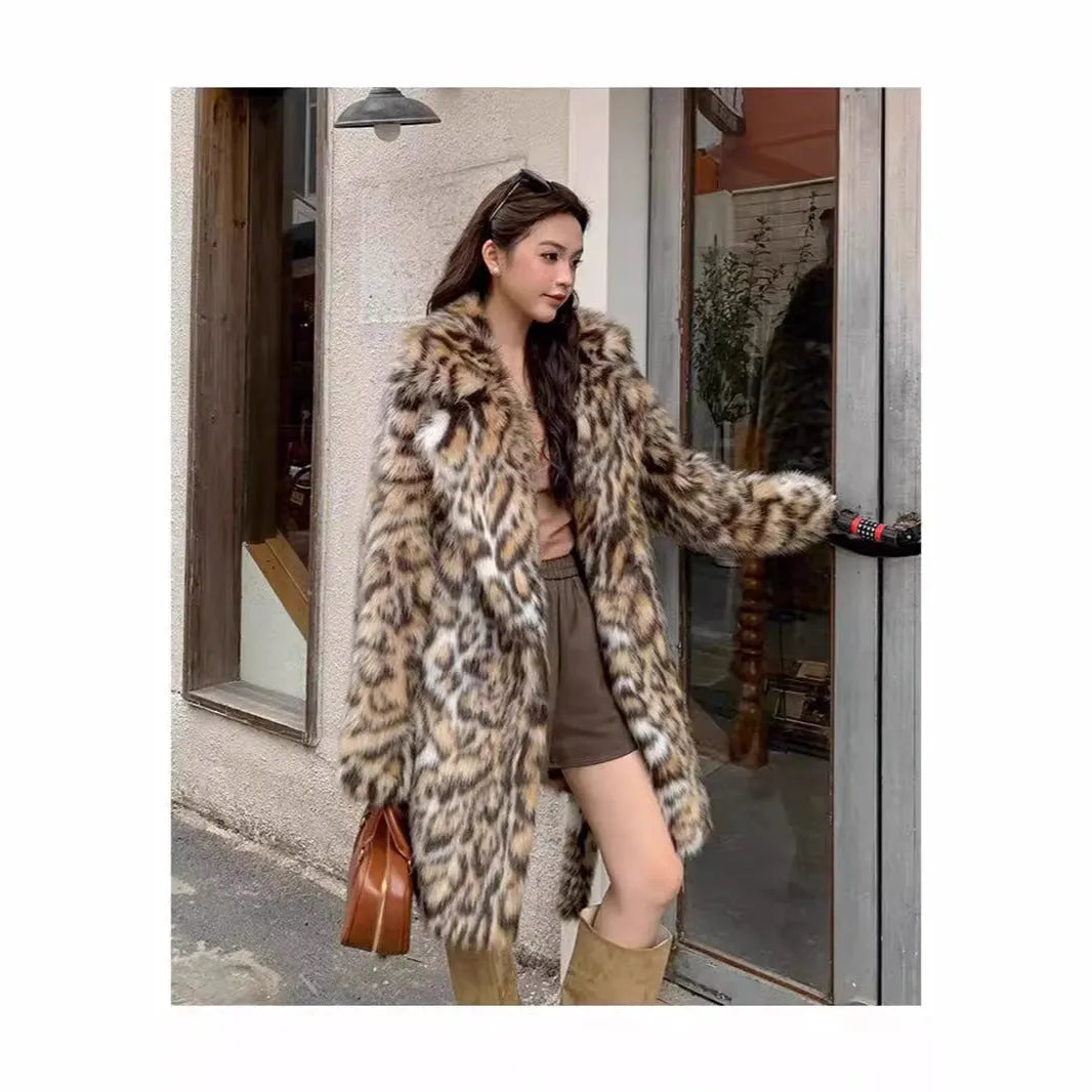 Long grey faux fur coat with a large fur collar and pockets on a model.