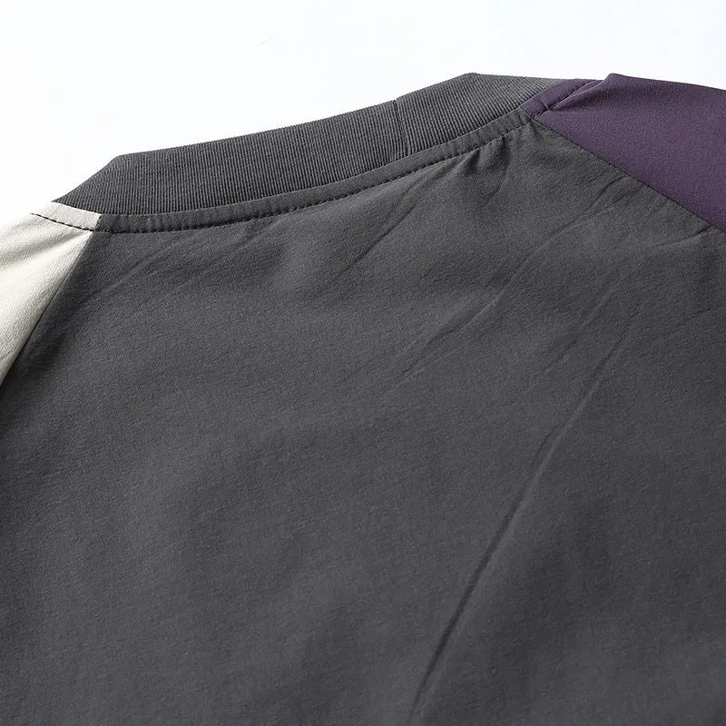 Dark grey men's loose fit T-shirt with contrast colour raglan sleeves on a hanger.