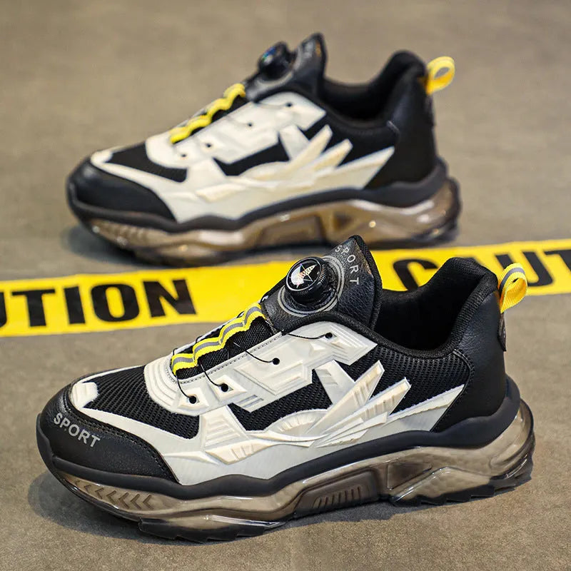 Men's black casual sneakers with rotating button closure and mesh upper on rubber sole.