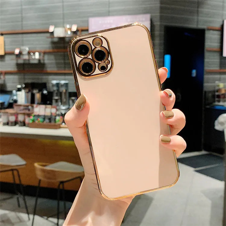 Gold plated and silicone stripe decorative case for iPhone on a solid colour background.