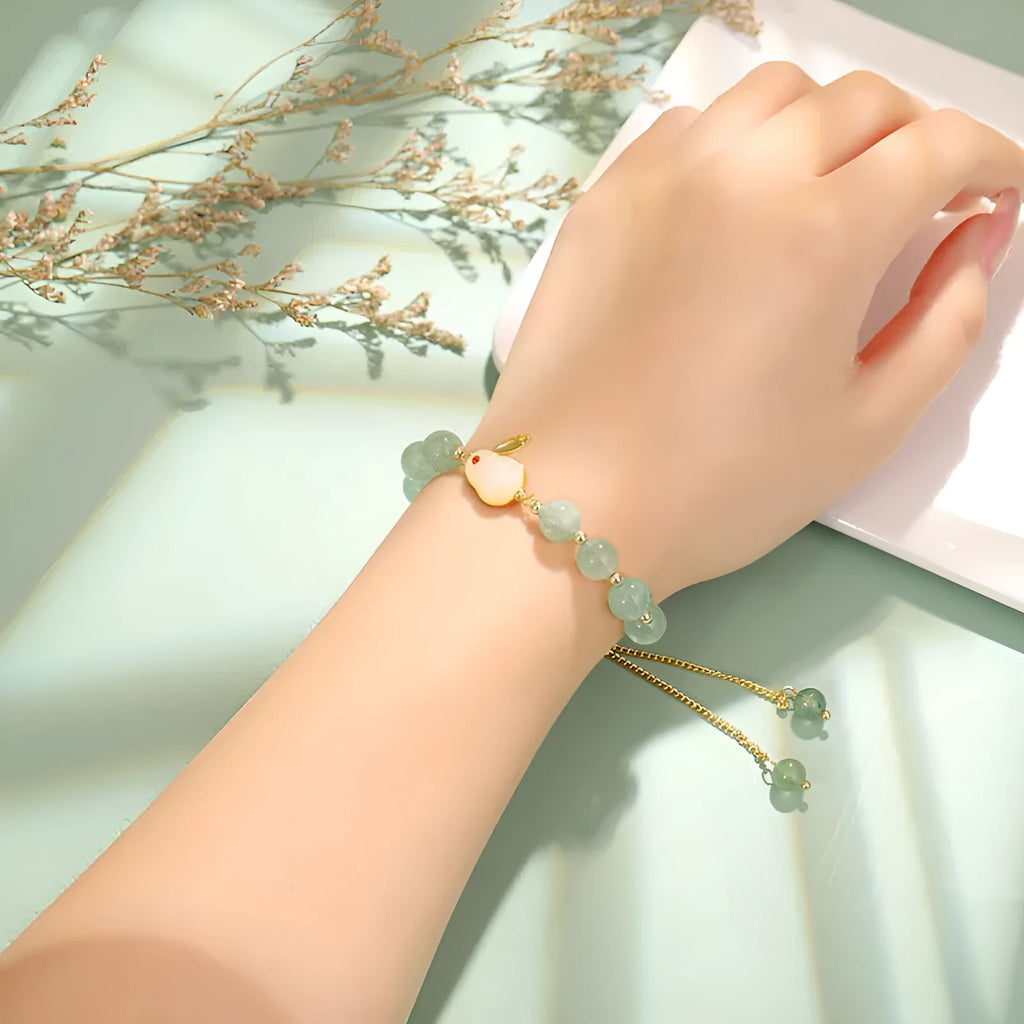Rabbit motif bracelet with green aventurine and strawberry quartz stones in gold and copper setting