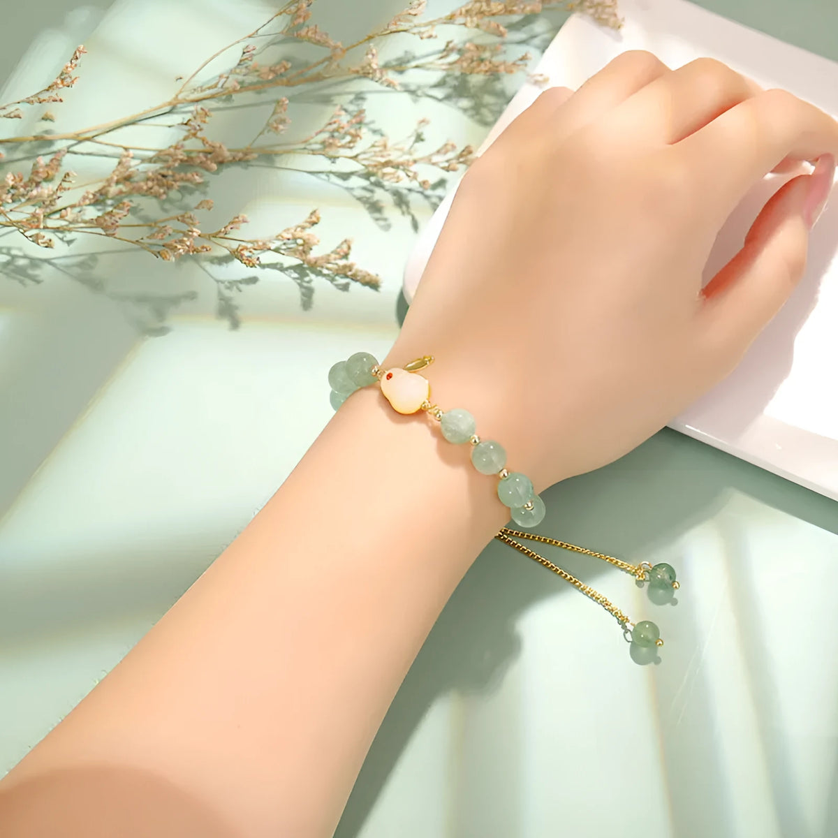 Rabbit motif bracelet with green aventurine and strawberry quartz stones in gold and copper setting