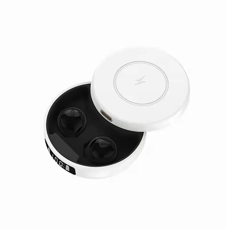 Mini black semi-in-ear wireless headphones placed inside their white wireless charging case, shown open.
