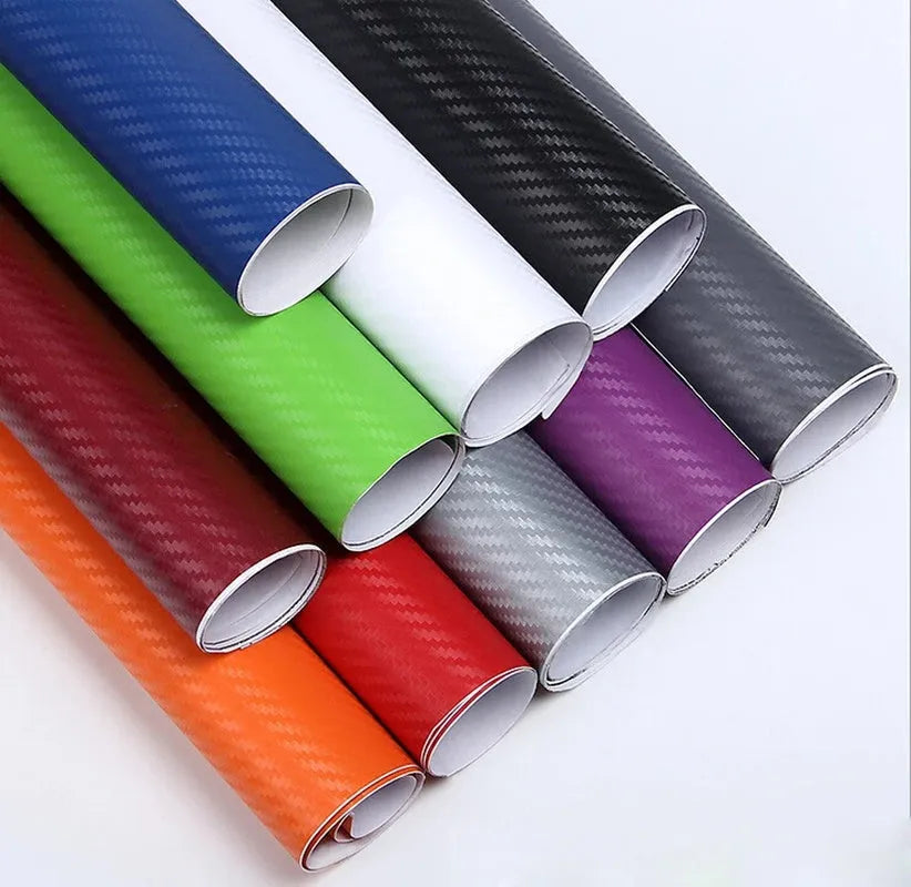 Roll of 3D carbon fibre car sticker showing black, silver, blue, and yellow colour options