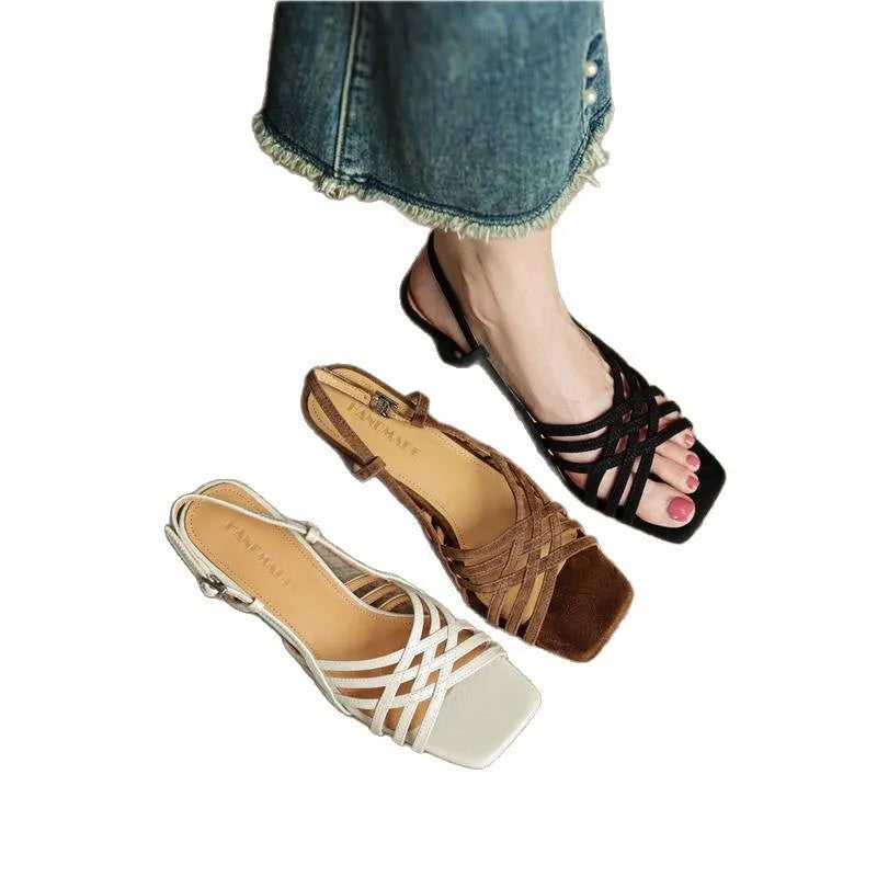 Retro-style women's sandals with thin cross straps, ankle buckle, and a mid heel.