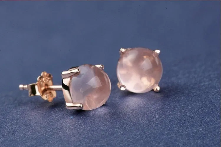Close-up of women's drop-shaped synthetic quartz stud earrings with a rose gold finish.