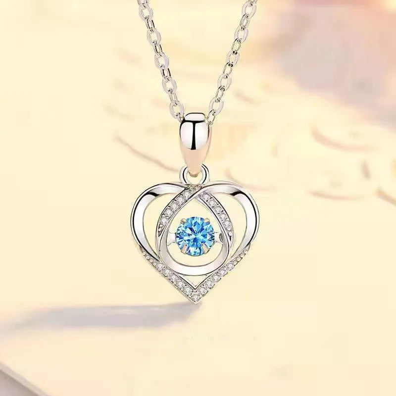 Blue diamond electroplated heart necklace and bracelet set with gem inlay on a geometric pendant.