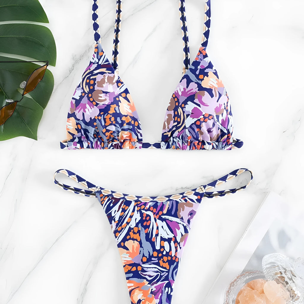 Women's floral print polyester bikini with triangle top and split-side brief bottoms.