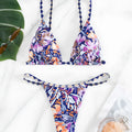Women's floral print polyester bikini with triangle top and split-side brief bottoms.