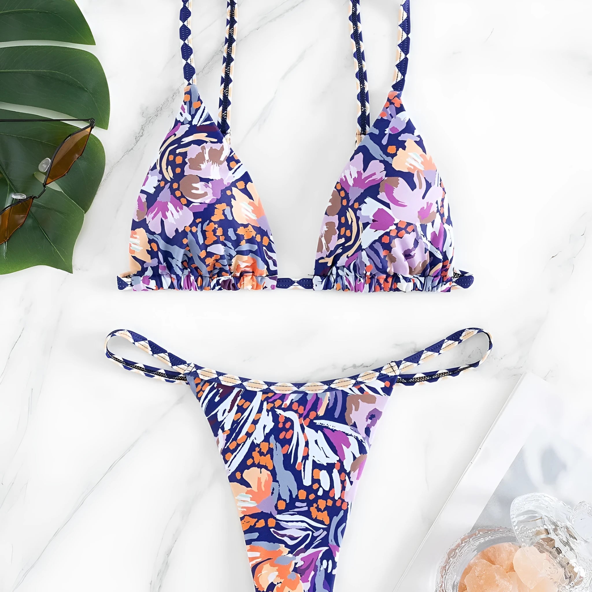Women's floral print polyester bikini with triangle top and split-side brief bottoms.