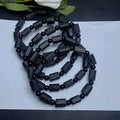 Natural black tourmaline rough stone bracelet with 10mm beads showing textured stone surfaces