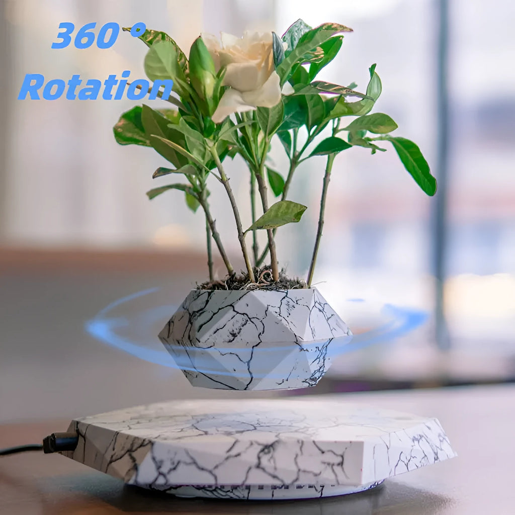 Magnetic levitating marble-colour plant pot floating above base with small plant