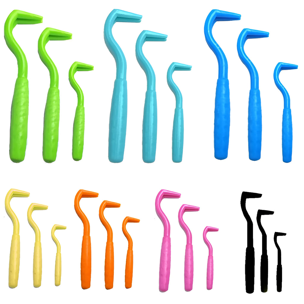 Set of three coloured tick remover hook tools for dogs on a white background.