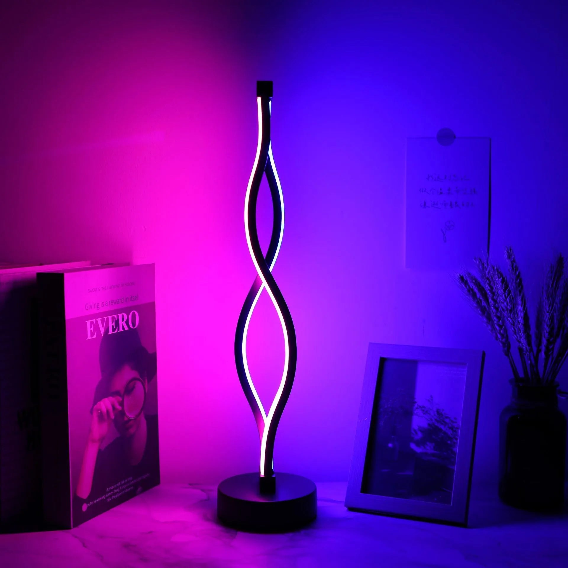 Black aluminium desk lamp with touch and button dimming controls on a desk.
