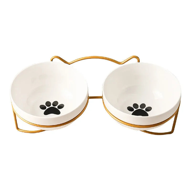 White ceramic cat bowl with decorative iron frame in cat footprints pattern