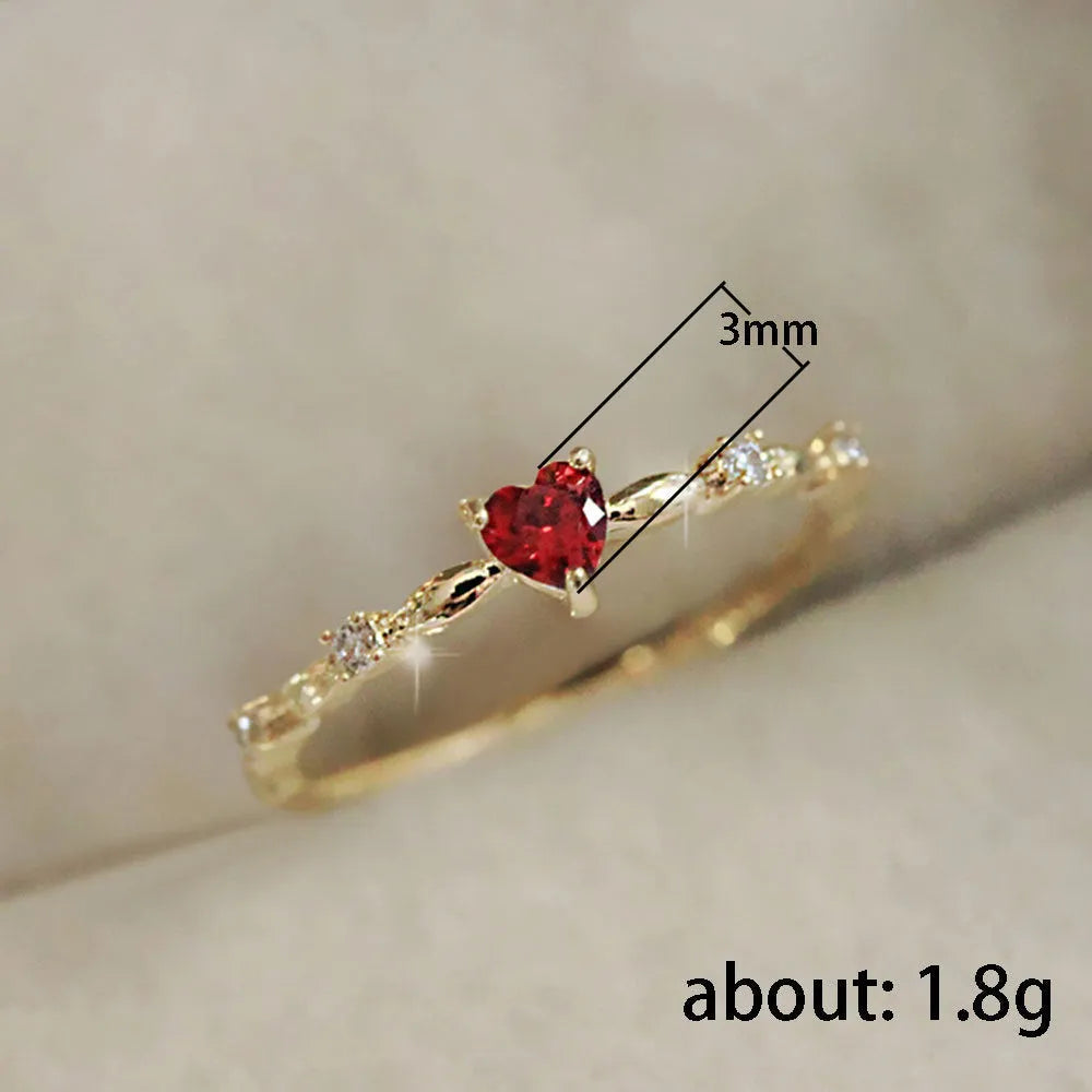 Gold or silver electroplated peach heart ring with zircon stones on a model's hand