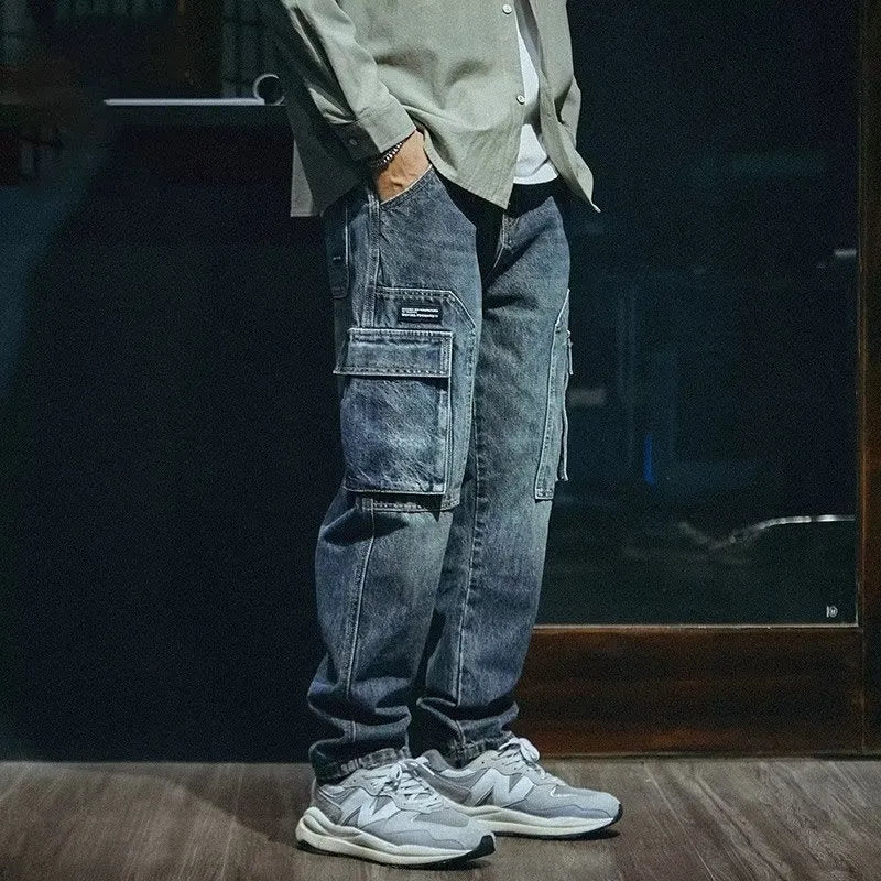 Man wearing blue loose straight-leg retro style stretch denim pants.