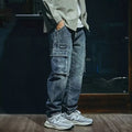 Man wearing blue loose straight-leg retro style stretch denim pants.
