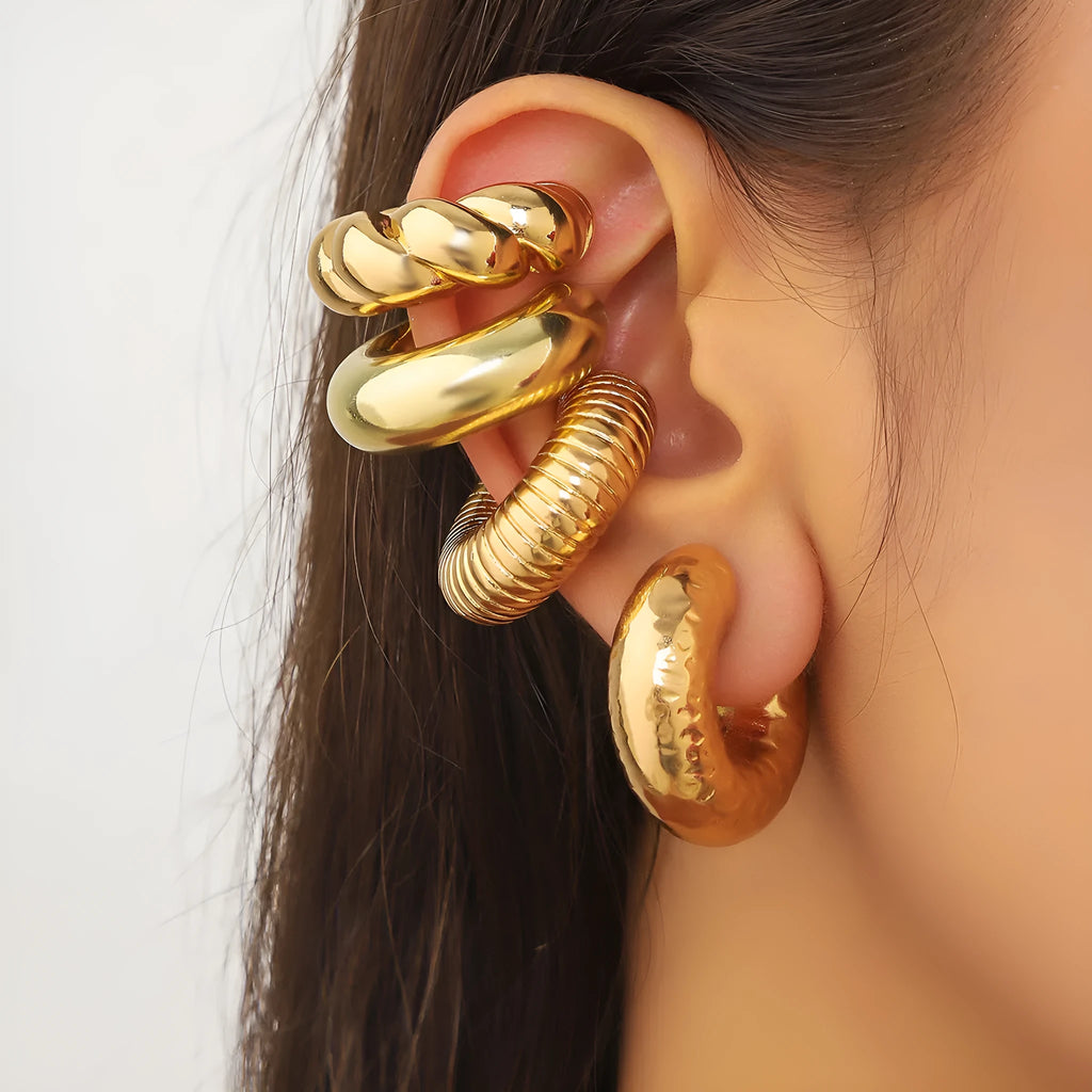 Geometric clip-on ear cuff set in gold and silver colours, four pieces displayed