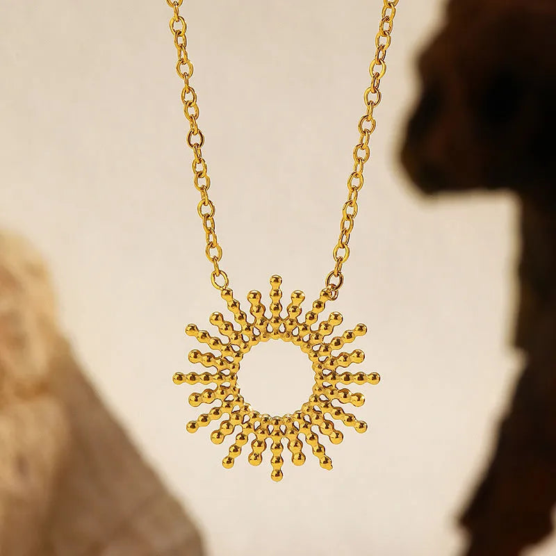 Gold tone geometric jewellery set with sun motif including necklace and bracelet for women