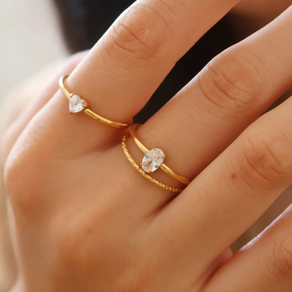 Golden electroplated stainless steel ring in love heart and oval shapes for women.
