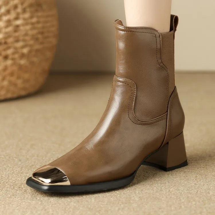 Brown cowhide leather women's Martin boots with side zipper and high heel on a white background.