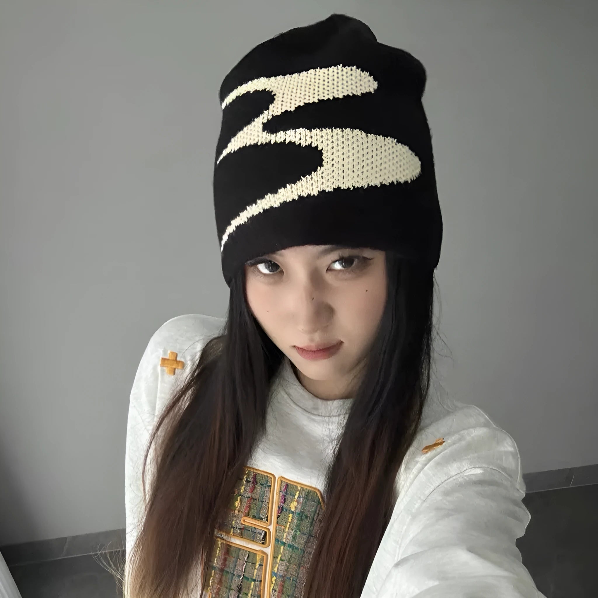 Acrylic knitted beanie hat in black, shown on a model, suitable for winter wear.