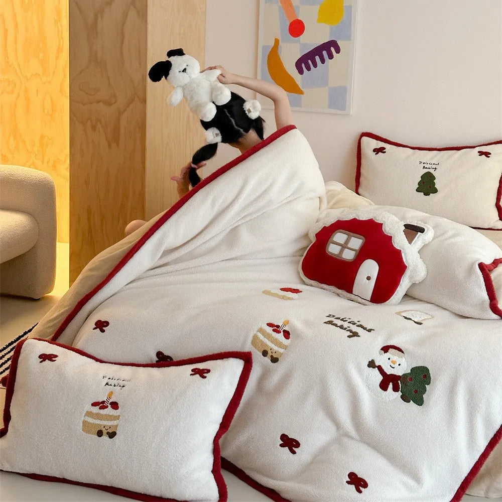 Winter Christmas cartoon snowman print bedding four-piece set on a single bed, showing duvet cover, pillowcases, and sheet.