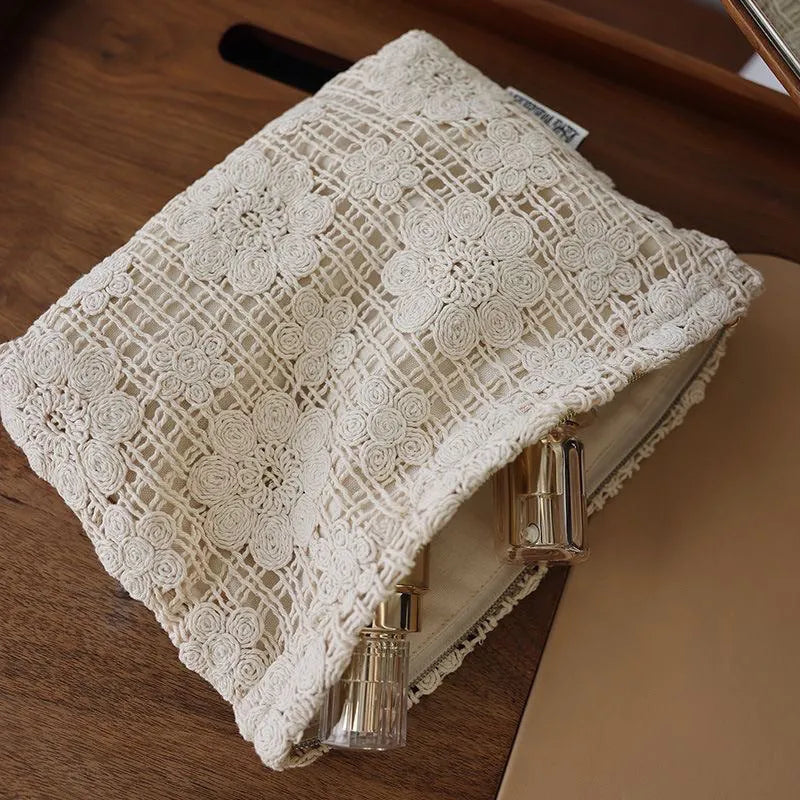 Handmade corduroy cosmetic bag with crochet flowers, ethnic embroidery, and a rope handle.