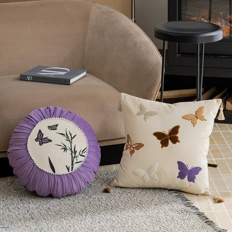 Square embroidered cushion with butterfly floral pattern in Chinese style, shown in beige colour.