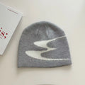 Acrylic knitted beanie hat in black, shown on a model, suitable for winter wear.