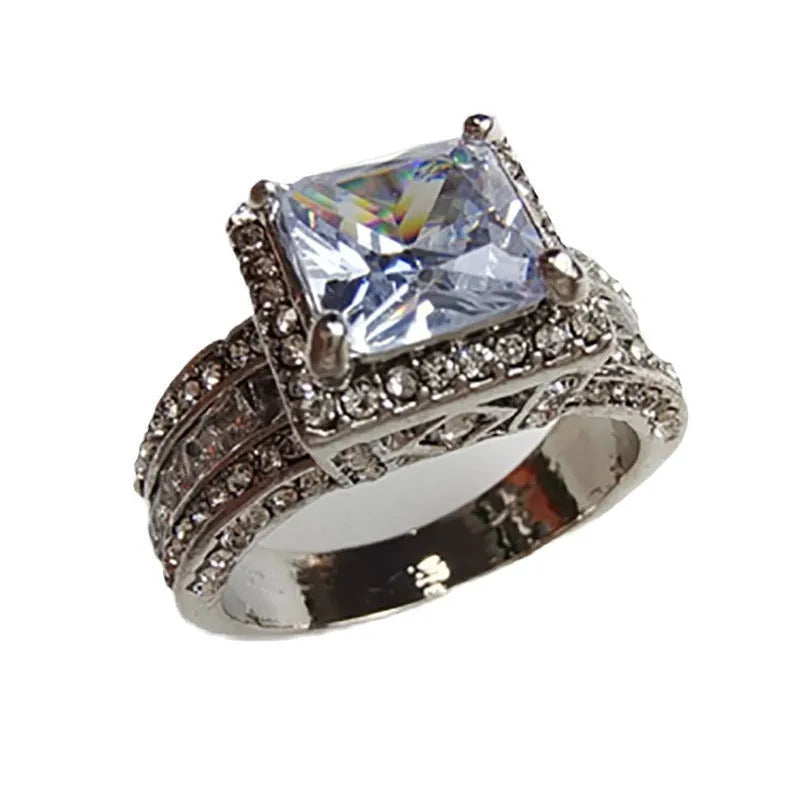 Geometric alloy women's ring in gold and white electroplated finishes on a size chart.