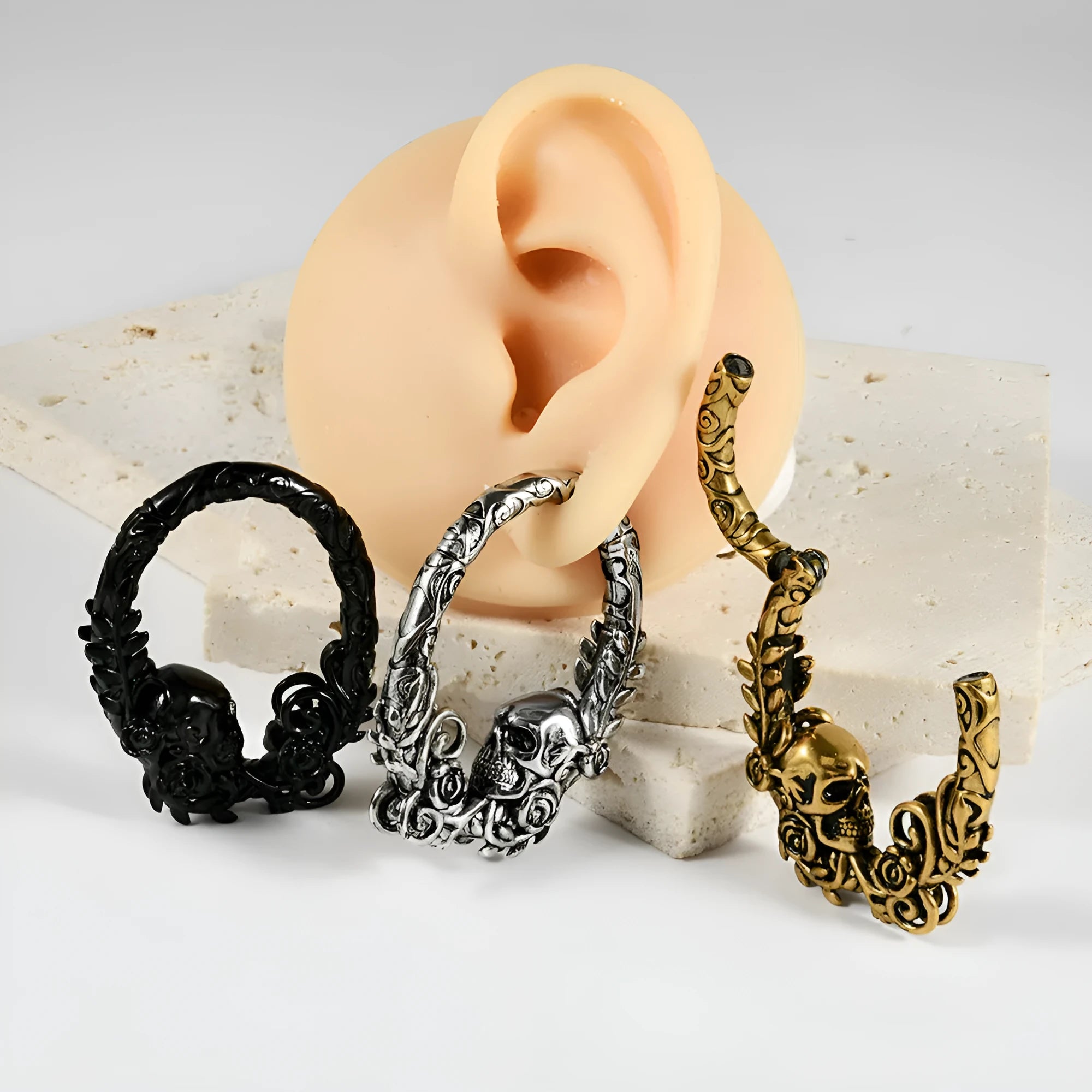 A pair of stainless steel fashion earrings with an intricate totem pattern design in a silver-toned finish.