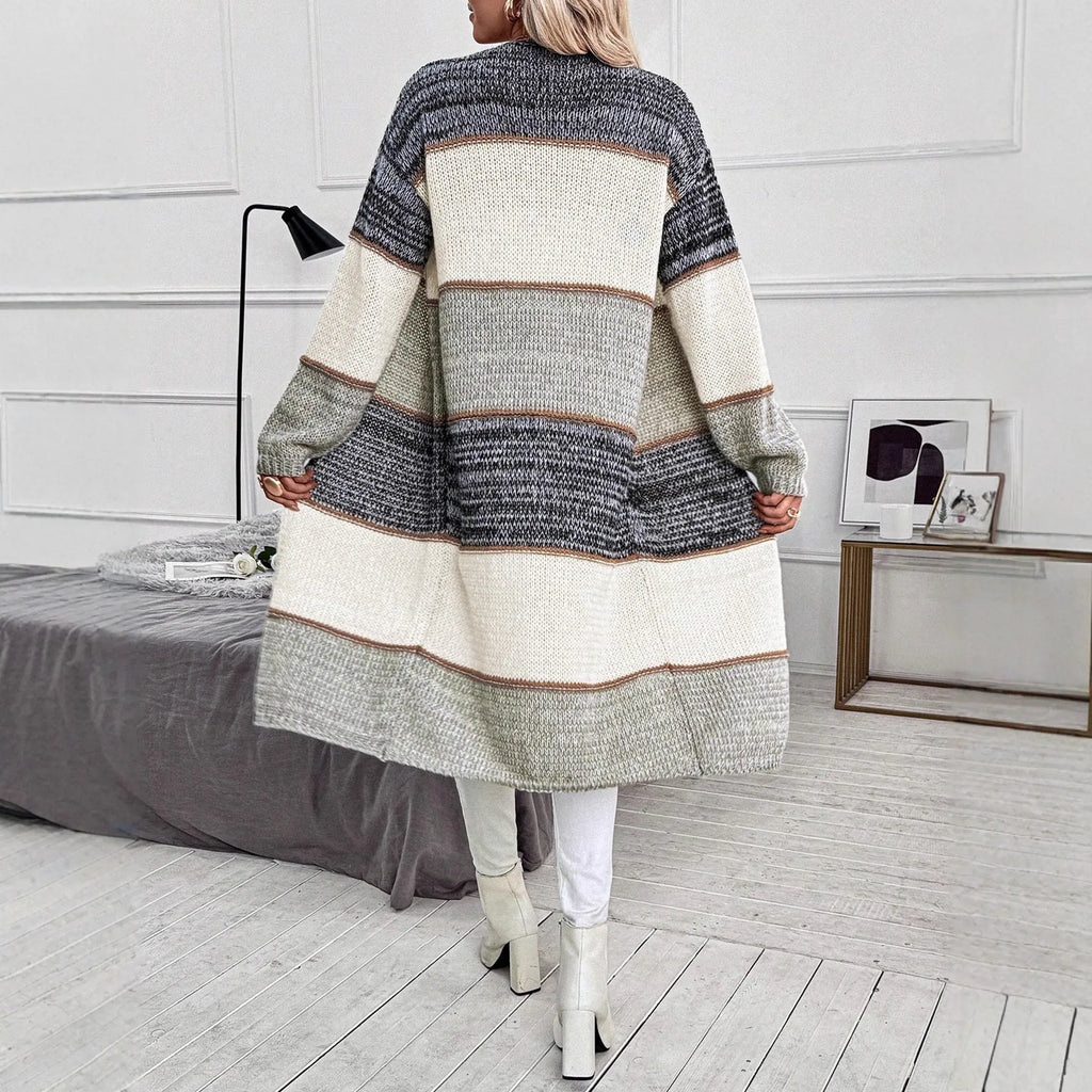 Grey striped women's long sleeve knitted cardigan on a hanger, showing loose fit.