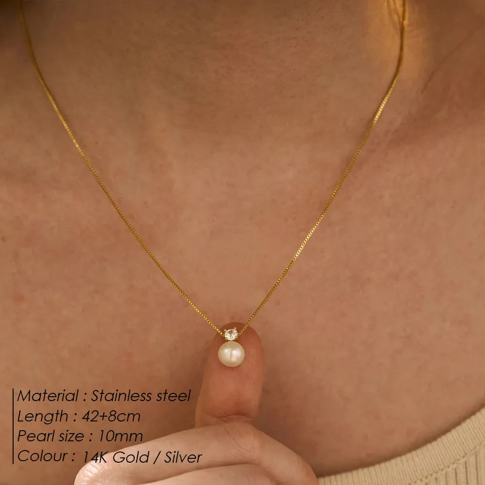 Gold and steel colour women's necklace with imitation pearl and zircon pendant on a stainless steel box chain.
