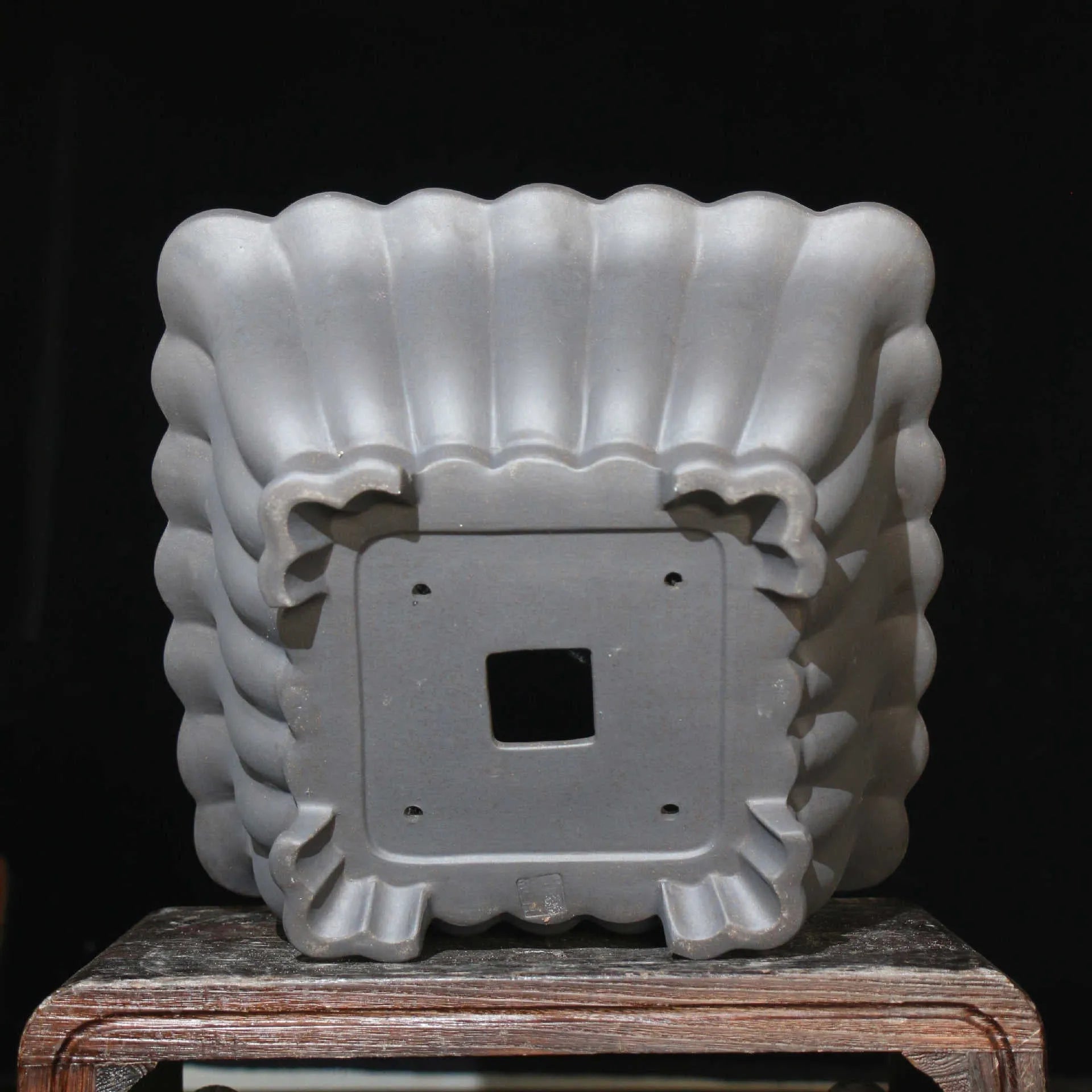 Square purple sand ceramic bonsai pot with warp device on a desktop.