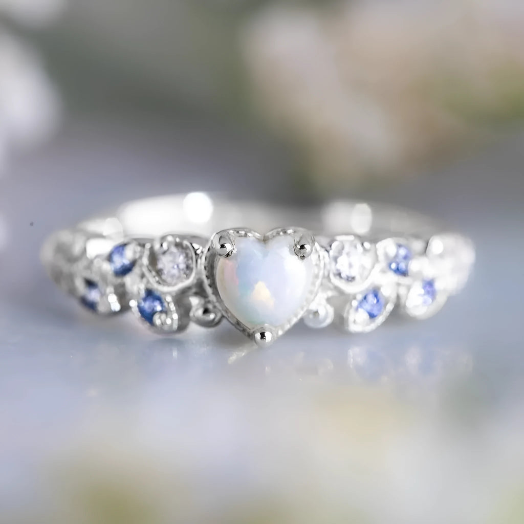 Peach-coloured alloy women's ring in a heart shape with floral and opal design details.