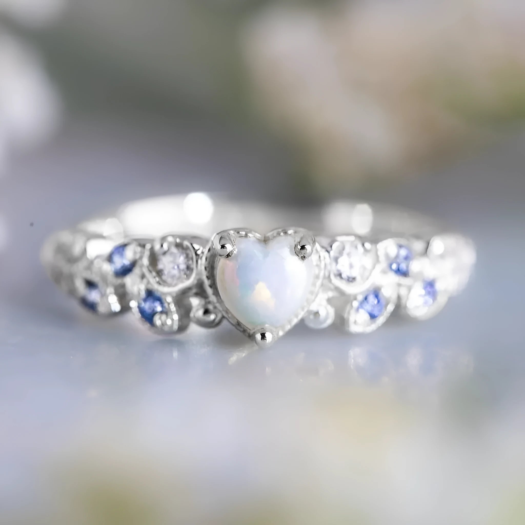 Peach-coloured alloy women's ring in a heart shape with floral and opal design details.
