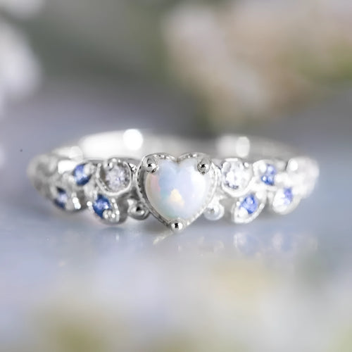 Peach-coloured alloy women's ring in a heart shape with floral and opal design details.