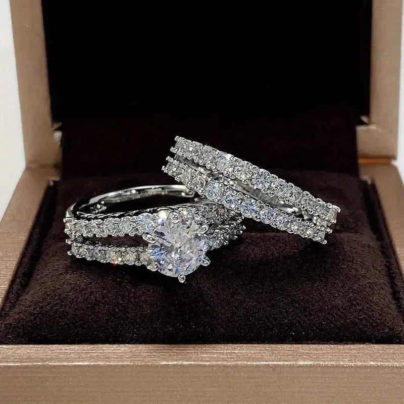 Two fully jewelled geometric round female rings in silver colour with diamond treatment surfaces