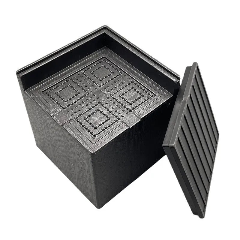 Four black plastic bed riser feet for increasing furniture height and creating storage space