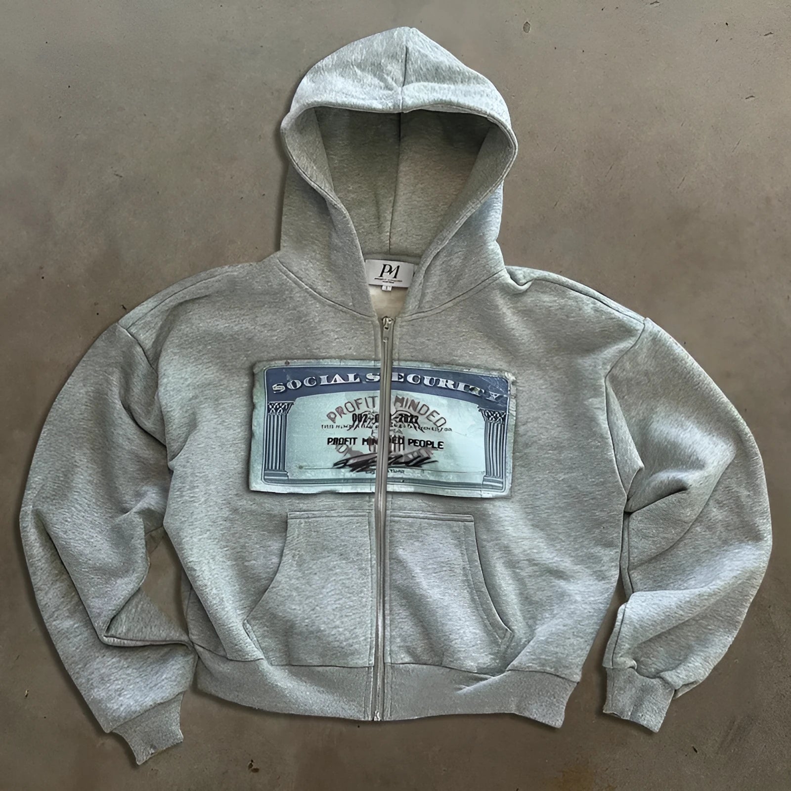 Loose fit unisex hoodie jacket with zip-up front, zippered pockets, and letter pattern design in black colour