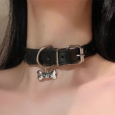Black adjustable dog collar with choice of cat paw, bone, or LD leather charm on a white background.