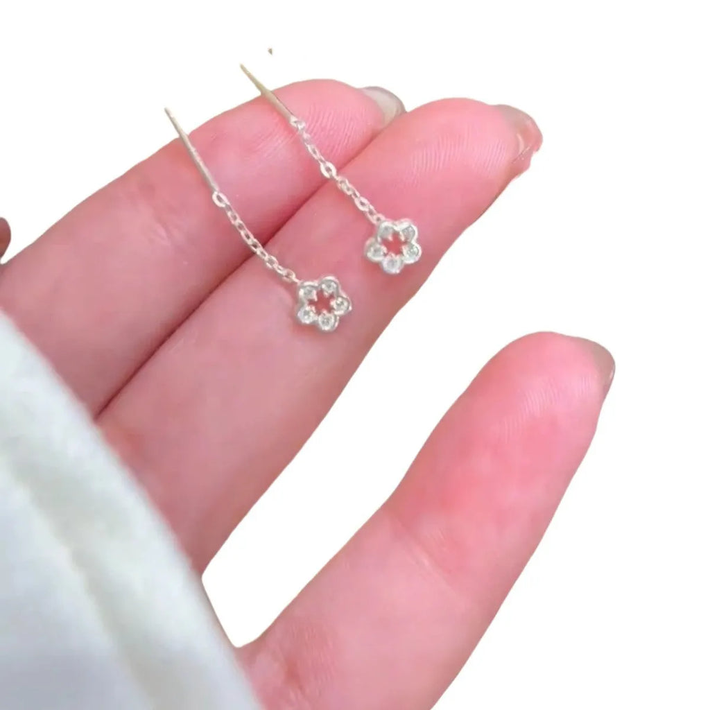 Pair of silver-coloured alloy flower stud earrings with hollow petal design