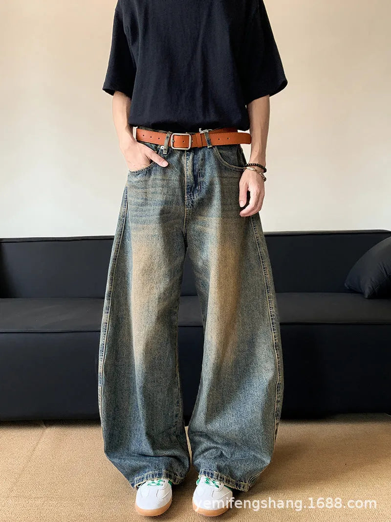 Men's retro blue distressed denim wide-leg trousers showing distressed detailing and wide-leg silhouette