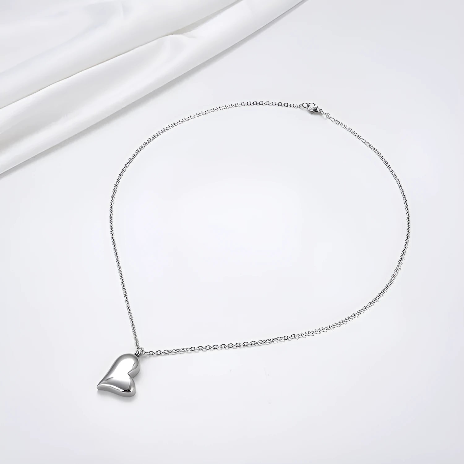 Curved peach heart stainless steel pendant necklace with silver electroplated finish