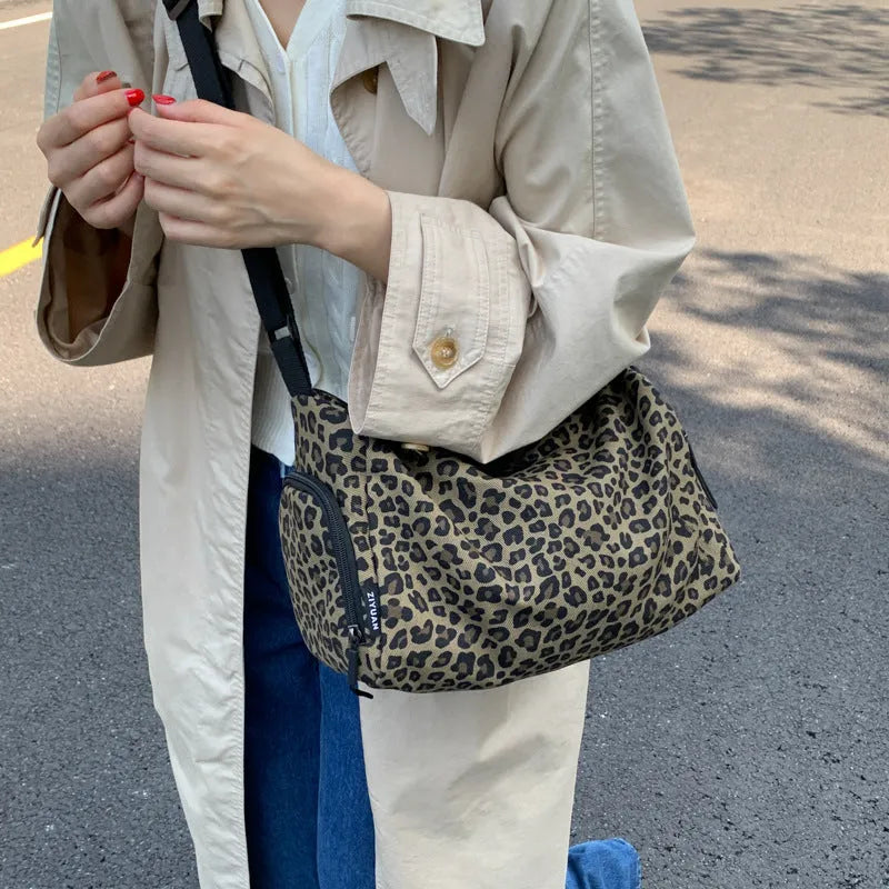Leopard print sports style shoulder messenger bag with cross-body strap and large main compartment