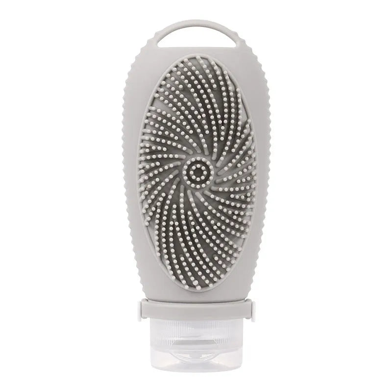 Silicone bath brush storage bottle in a choice of colours including pink and sea blue on a bathroom counter.
