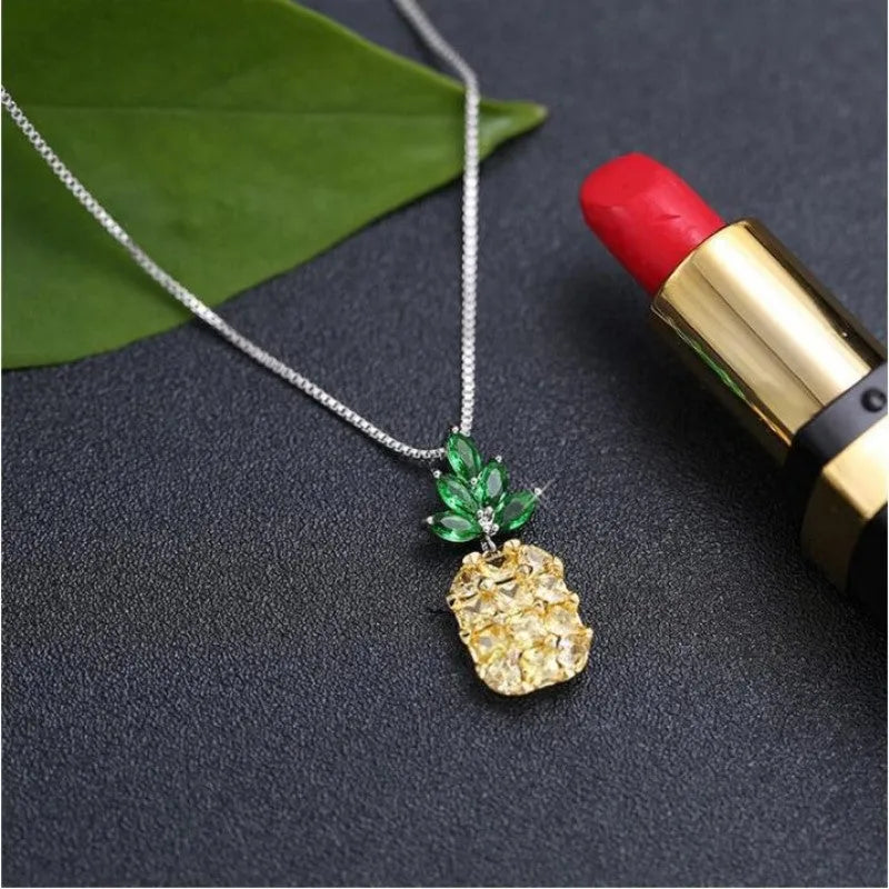 Silver plated women's necklace with a geometric pineapple diamond pendant charm.
